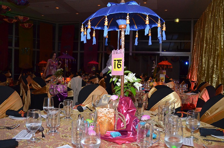 The ballroom of the Chelsea Center was decorated with dozens of bright colored umbrellas on the tables and ceiling.