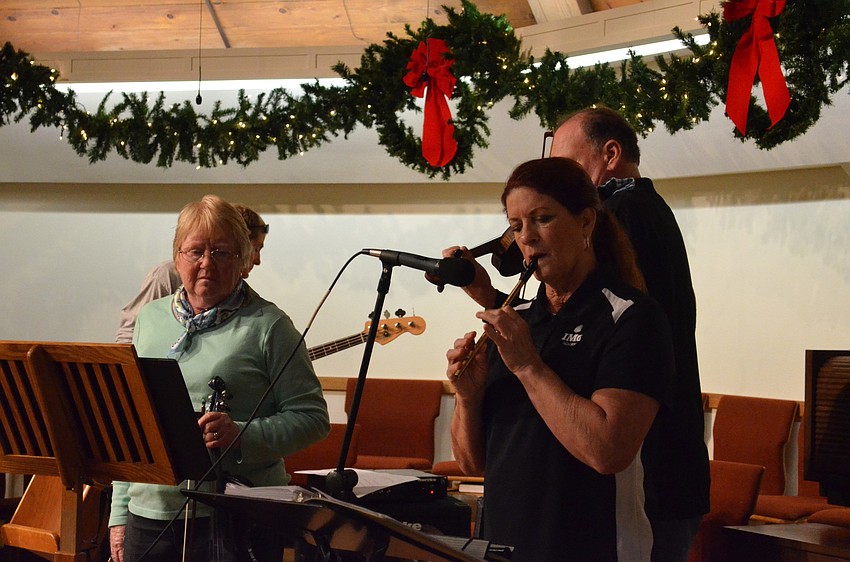 Frances Lutz, fiddle, and Mary Giroux, whisper, rehearse their parts for the concert.