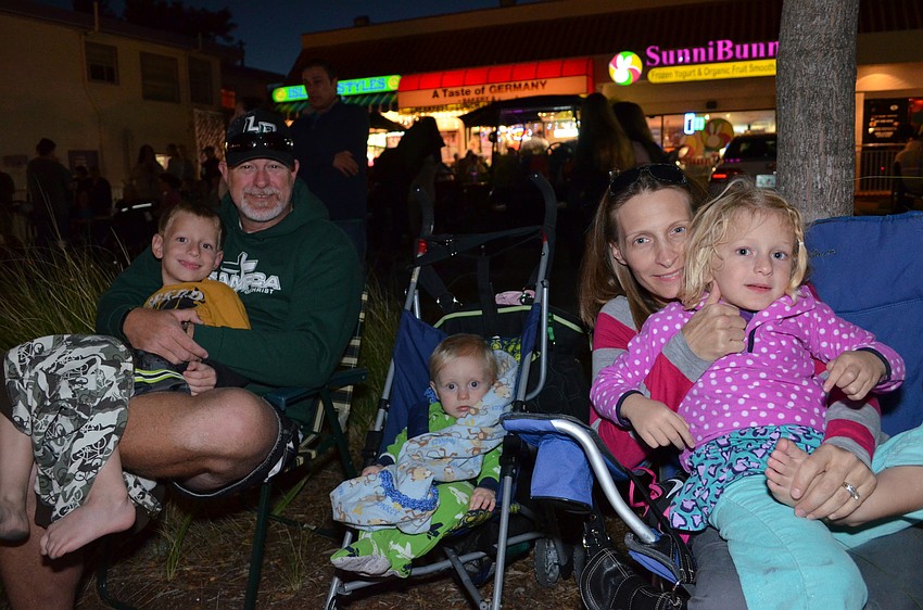 Tim and Amy Ferguson wait for the parade to start with their children Brady, Caleb and Riley.