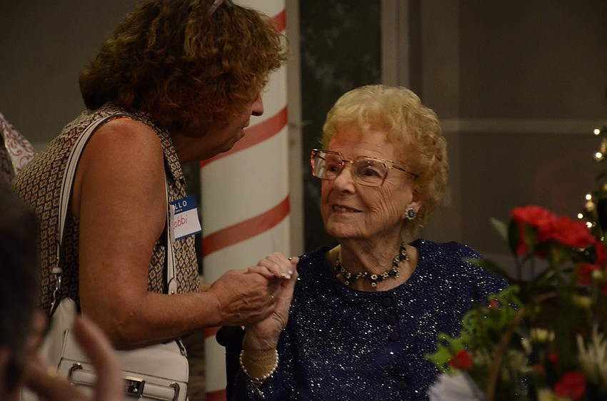 Robbi Sierra speaks with Norma Martin during her early birthday party.