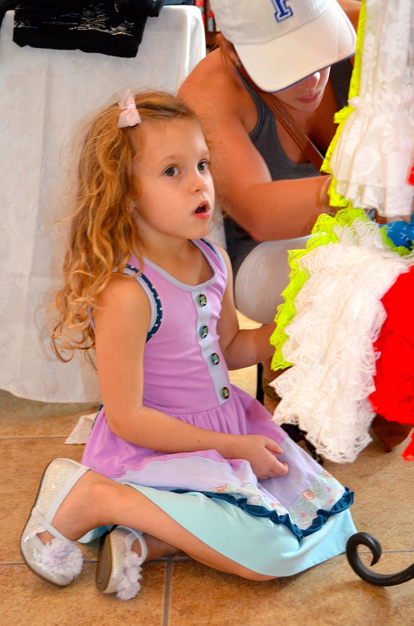 Kinley McCaw spots a holiday dress she likes.
