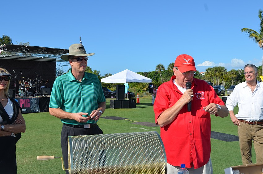 John Wild, of the Longboat Key Kiwanis Club, announces the winner of the raffle, Riana Rawson.