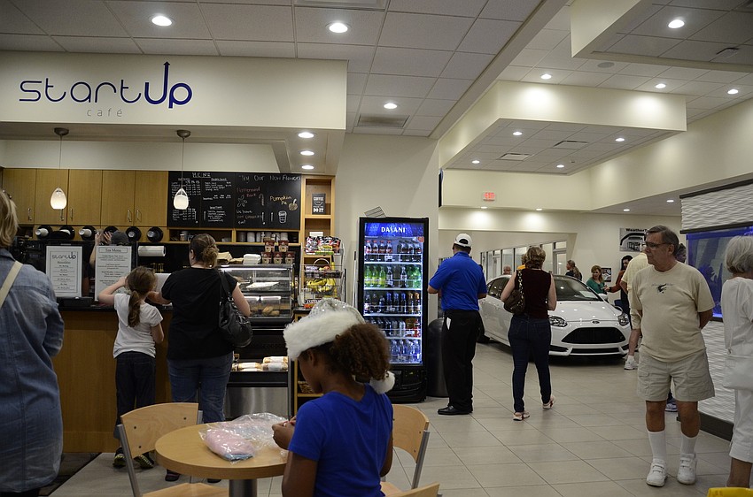 The new facilities in Sarasota Ford include a cafe, aquarium and a theater for customers.