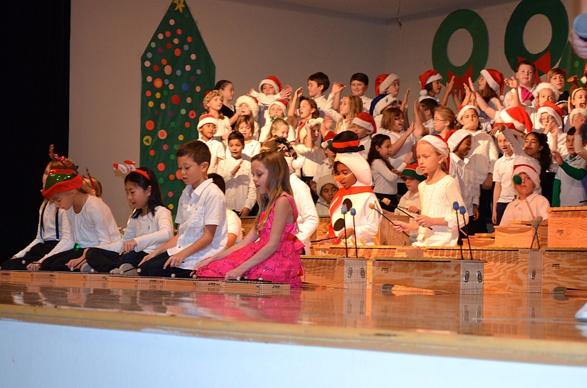 The performance featured instruments and singing by third-grade students.