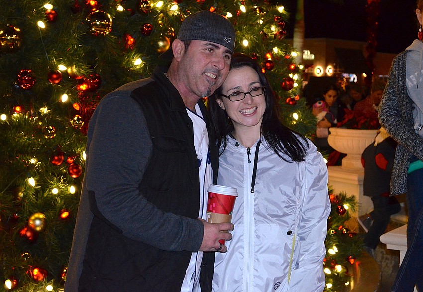 Scott and Julie Gregorio pose in front of Main Street's Christmas tree.