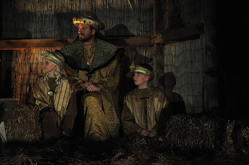 Fairyn, Lance and Davis Weigand present gifts to baby Jesus.