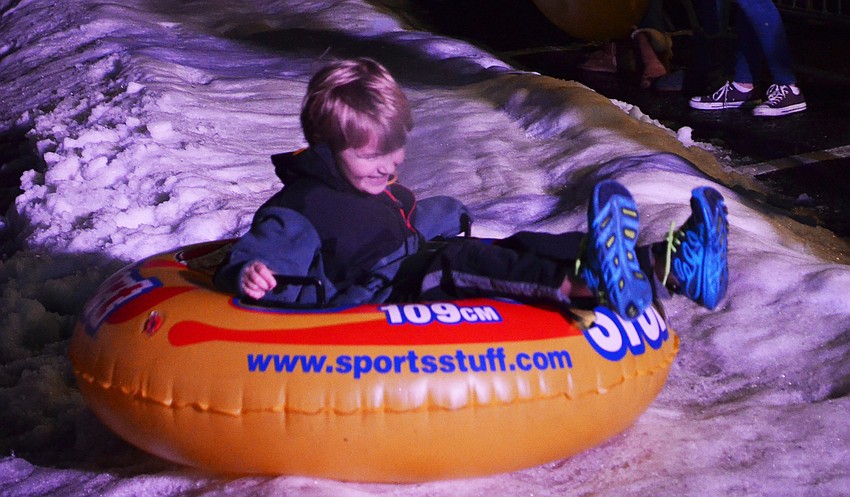Tucker Gravley takes a ride down the snow slide.