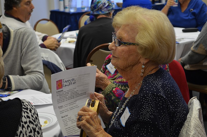 Shirley Brodsky taps her tambourine along with music.
