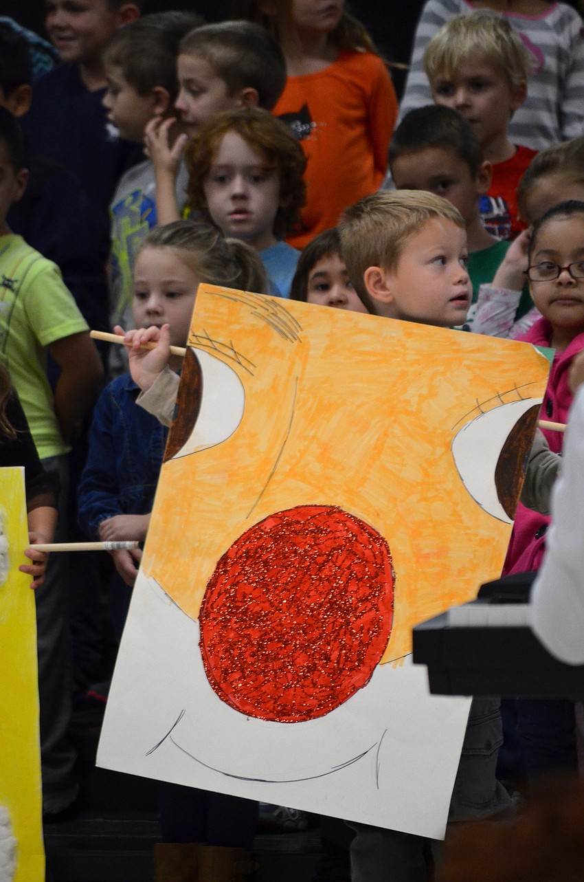 Landon Perry displays a Rudolph sign during the show's last song.