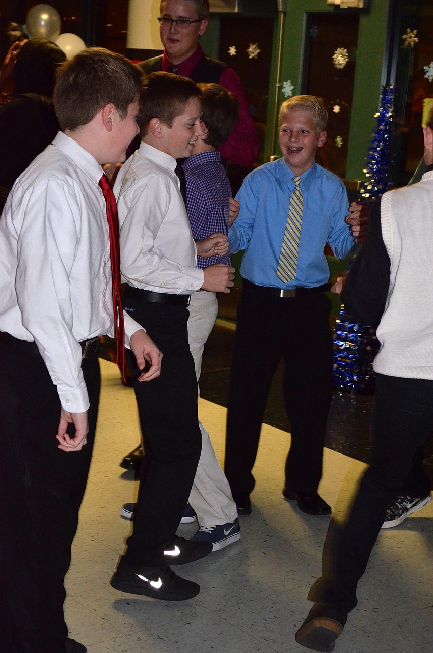 The boys dance as much as the girls throughout the evening.