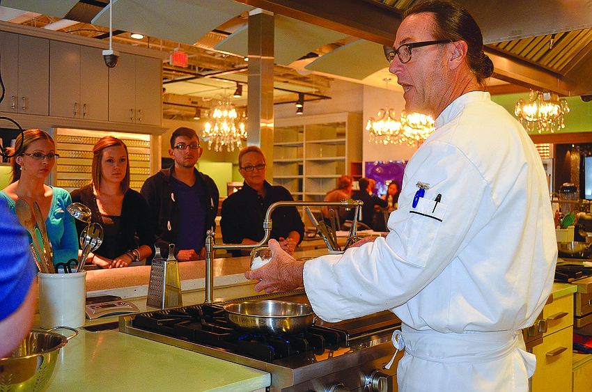 USF Sarasota-Manatee instructor Garry Colpitts demonstrates a cooking technique before assigning students soups to prepare.