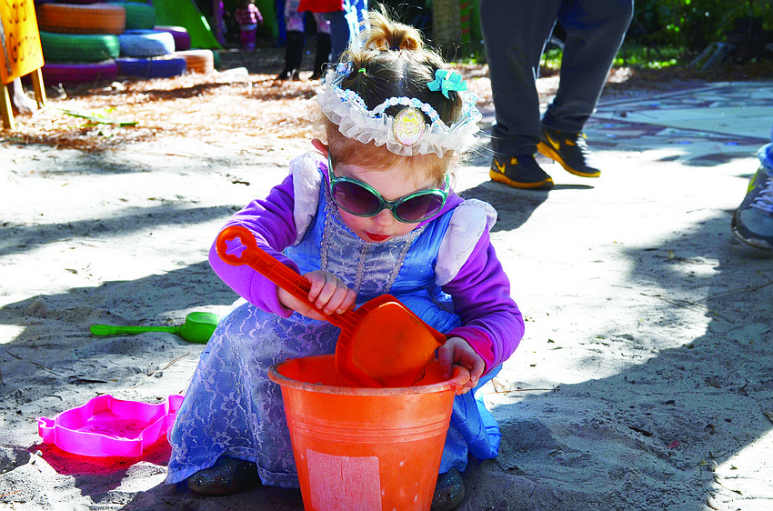 Elle Singerman plays in the sand at the Sarasota Children's Garden, during Temple Emanu-El's Tu B'Shevat celebration.