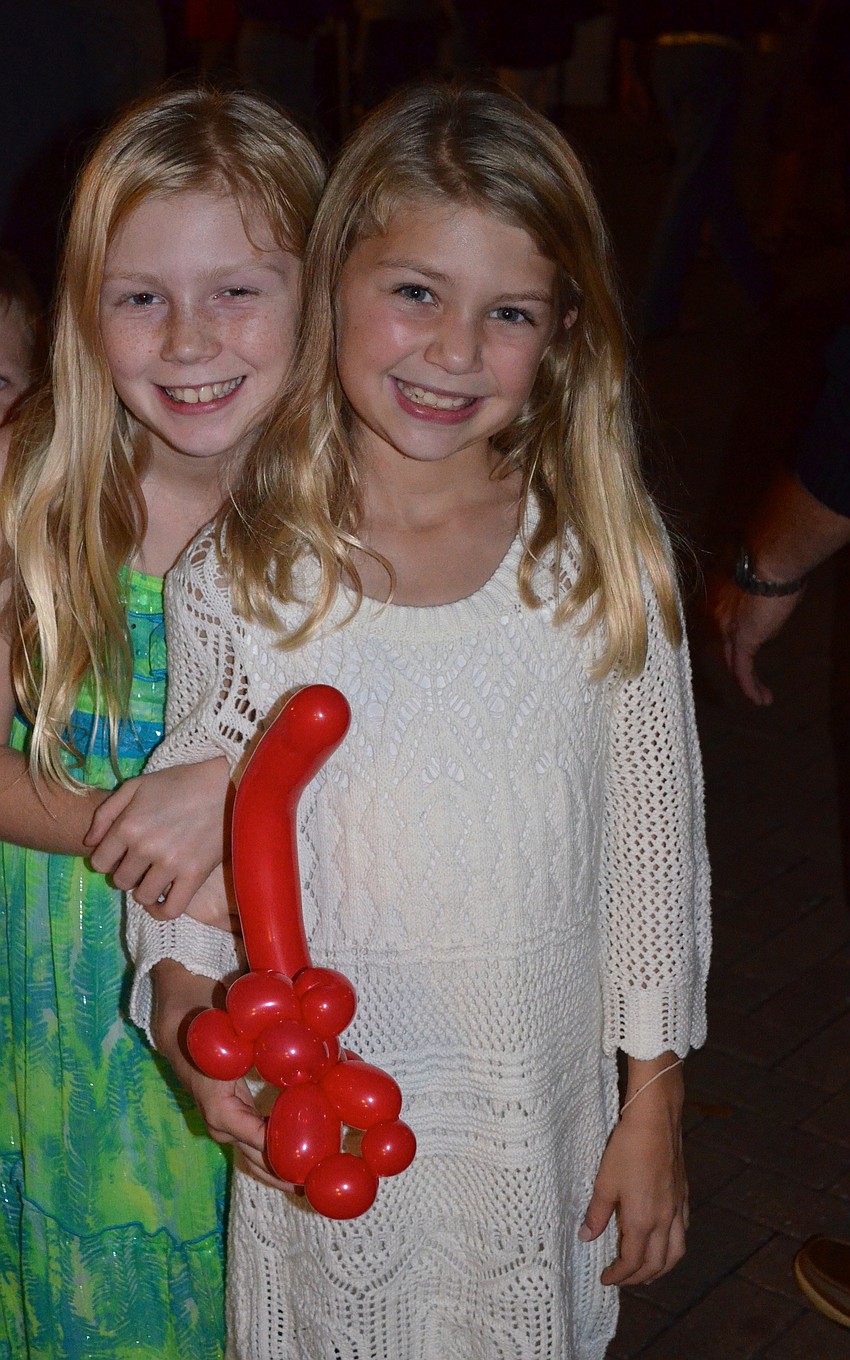 Sisters Kaitlyn and Alexa Hornung show off their balloon figures.