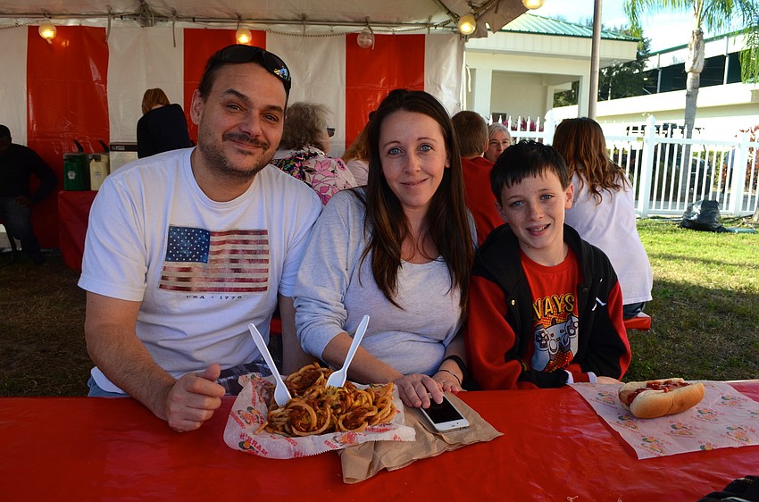 The Holschwander family â€” Michael, Michelle and Ryan â€” enjoy fried snacks.