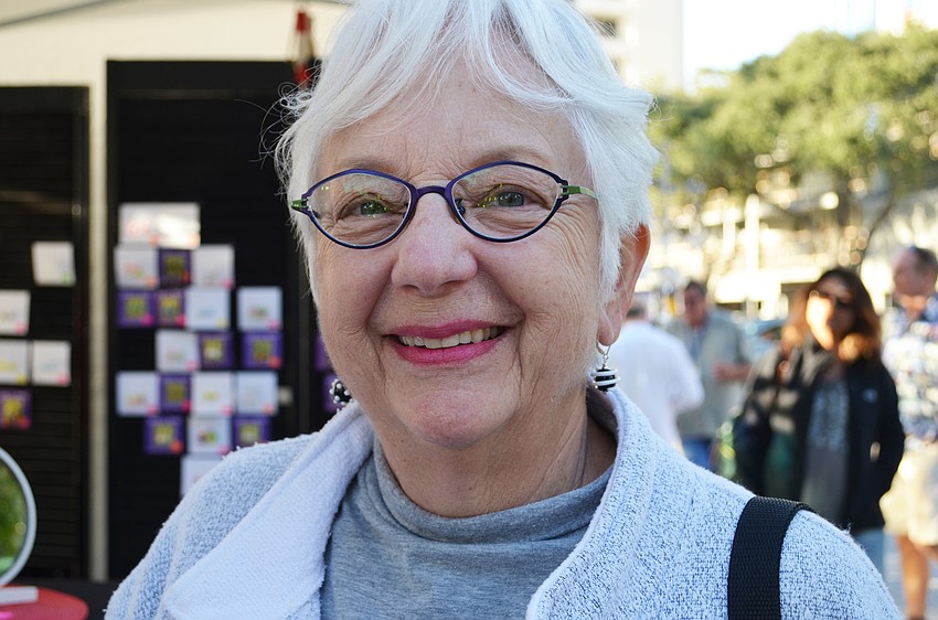 Phyllis Kalk shows off her new earrings from the Jasmine Keane jewelry booth.