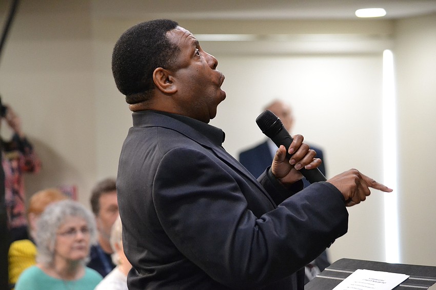 Westcoast Black Theatre Troup founder Nate Jacobs lead members in song.