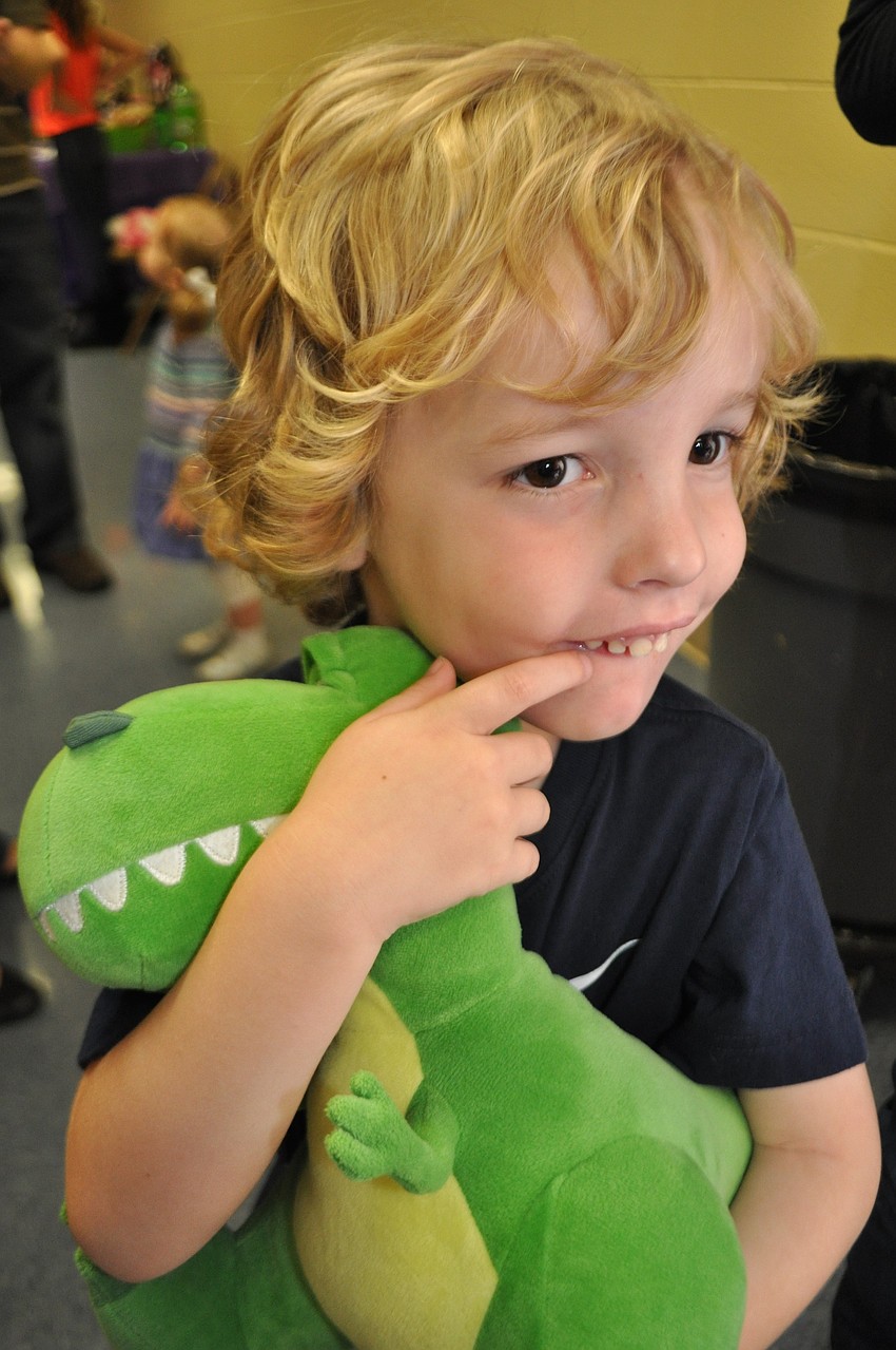 Connor Stablein, 3, loves the dinosaur he won at a game.