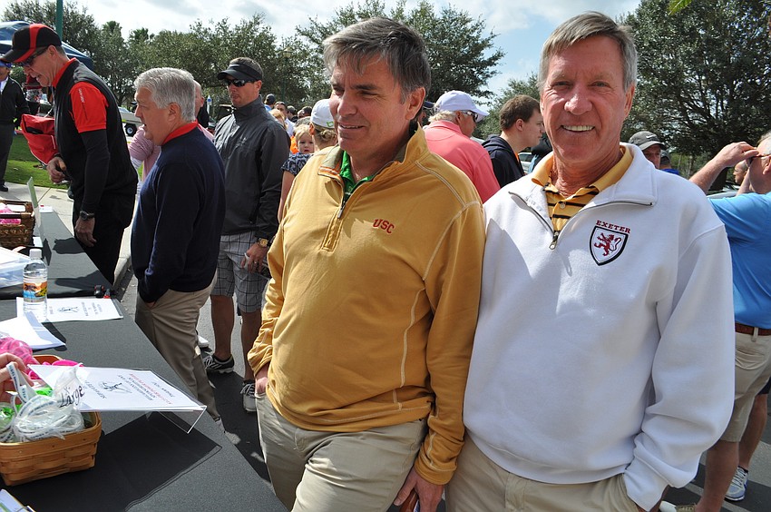 Chris Nee and Bill MacAlpine register for the golf tournament.