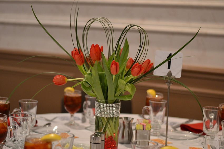 Centerpieces kept with the love theme with red tulips and hearts.