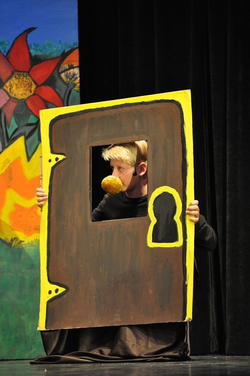 Owen Corr, the door to get into Wonderland, whines after Alice grabs his nose.