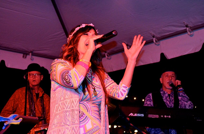 Paisley Craze lead vocalist Sudie Brattli sings 60s songs for a growing crowd.