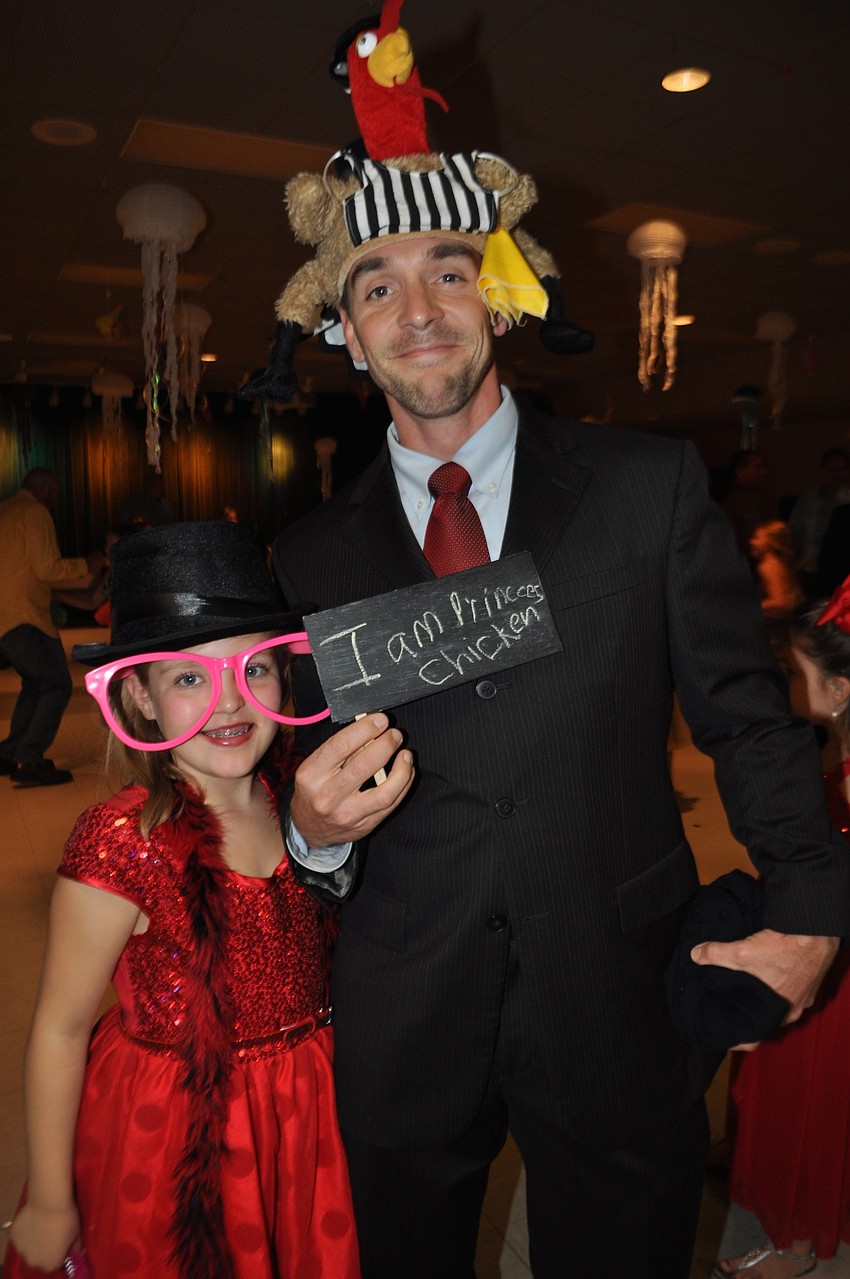Zoe Bell, 8, dresses her dad, Rob, for the photo booth.