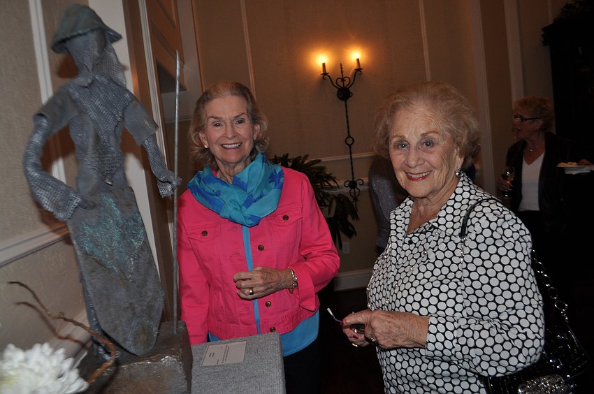 Artists Pat Britt and Cris Irvin look at the work of fellow artists.