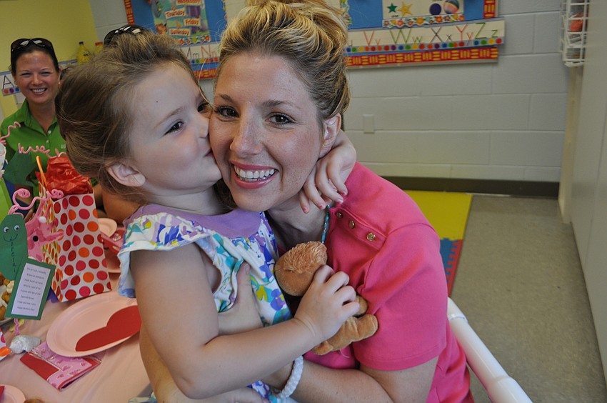 Loreilai Kelley, 4, gives her mom, Janeen, a kiss before breakfast.