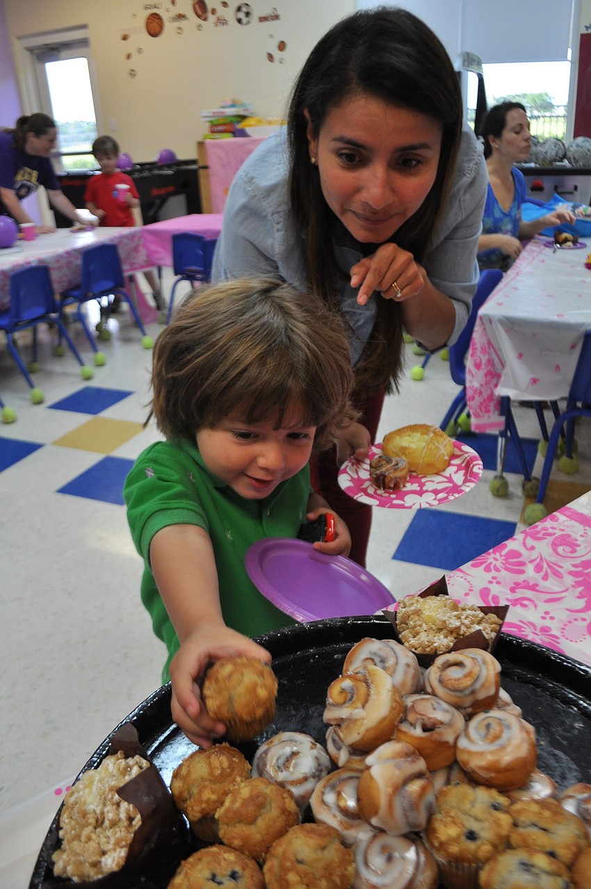 Fen Rand, 3, and his mother, Vanessa, select danish for breakfast.