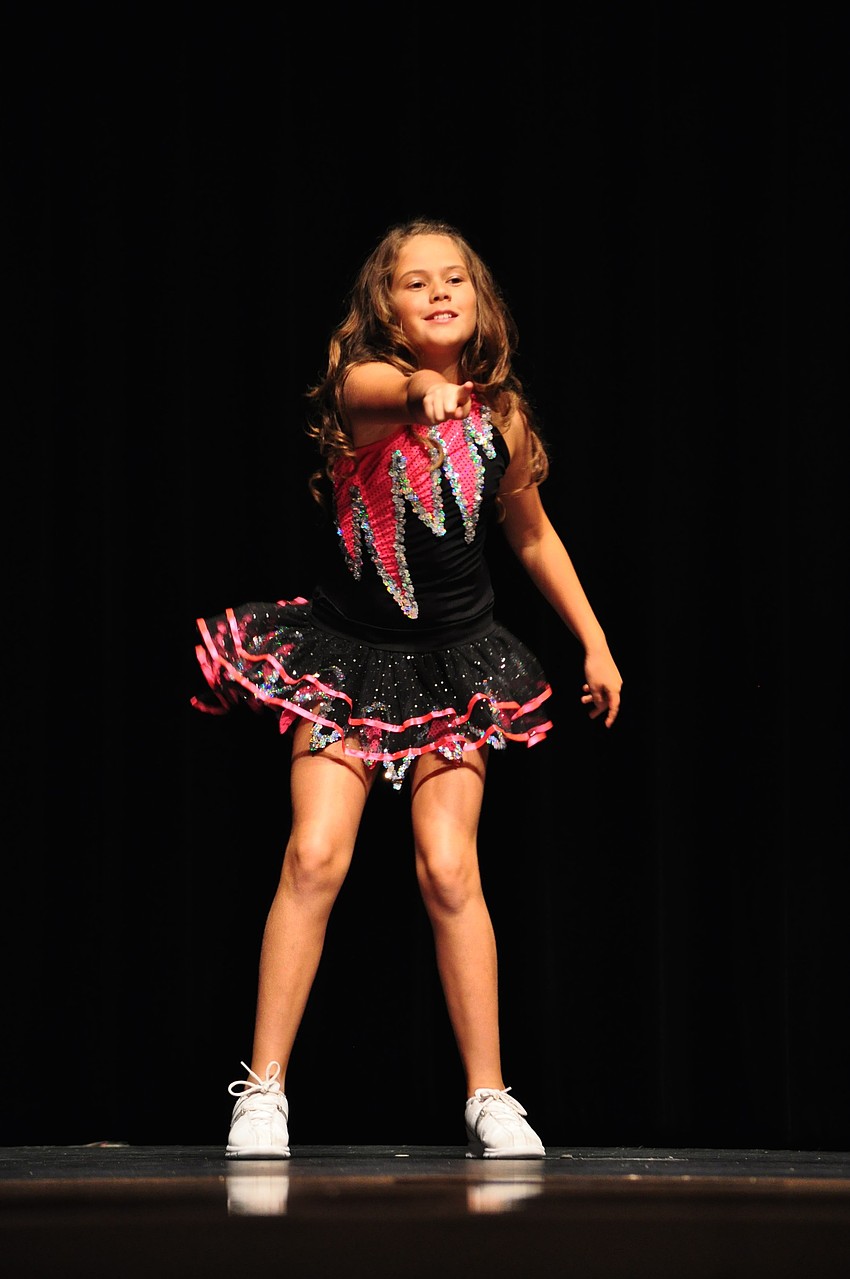 Isabella Busi, of Tara, points to the audience during 