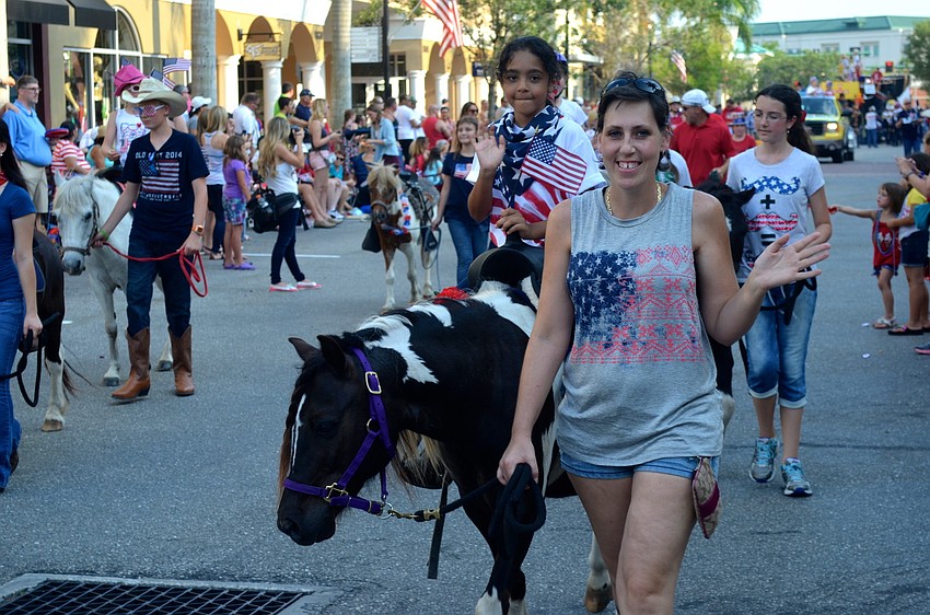Avrianna Isles rides her horse beside her mother, Kim Goglia.