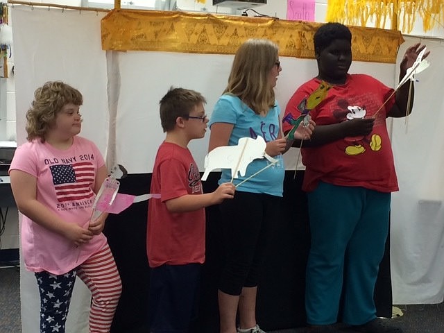 Anabela Burns smiles as she performs with her puppet.