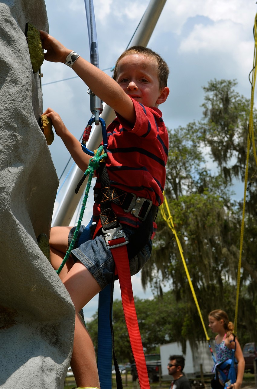 Bradford Andrews climbs the rock wall.