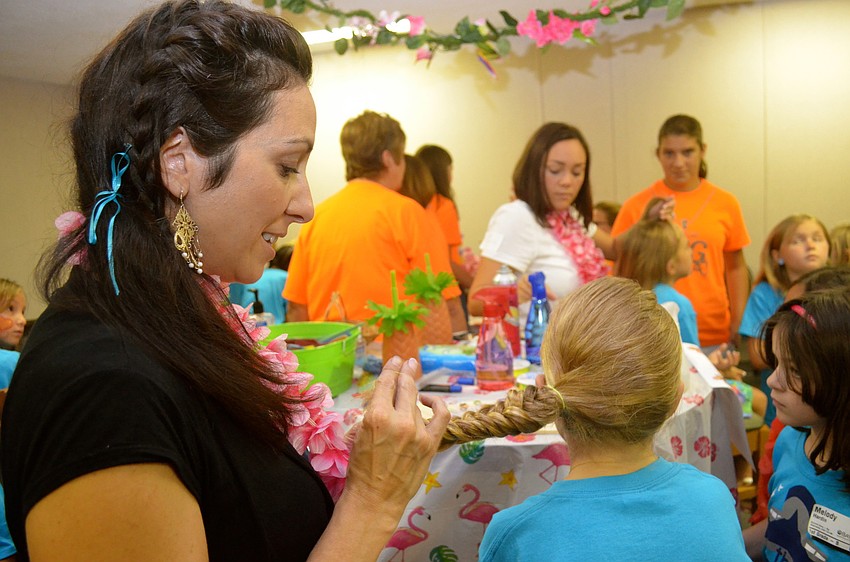 Christa Hardin braids hair for the attendees.