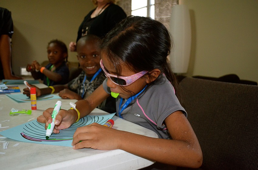 Emma Pereyra eats her candy and colors.