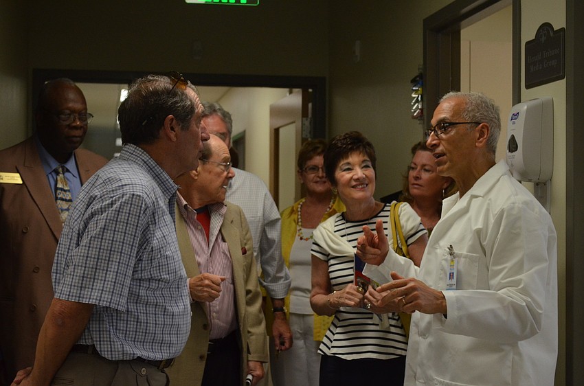 Dr. Muni Rizkallah shows visitors the pediatric rooms.