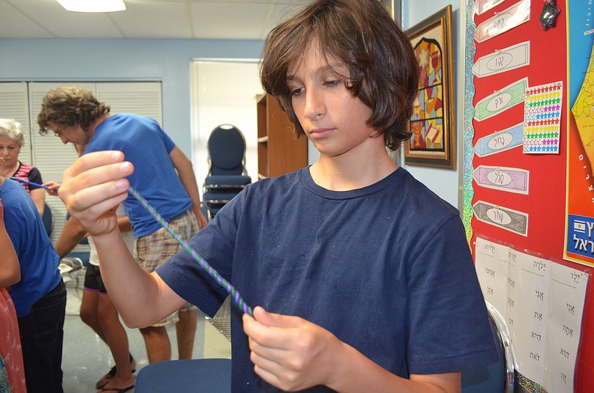 Leo Glickman twists his candles to make a spiral.
