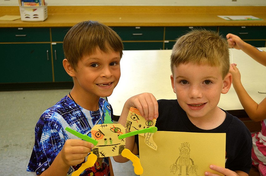 Caden Viola and Caleb Hodge make crafts to bring home later.