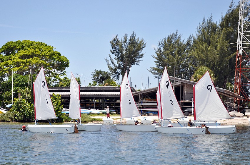 Students sailing optiâ€™s in the SYSP summer sailing camp head out into Sarasota Bay from the beach at Sarasota Sailing Squadron.