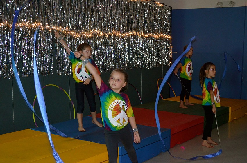 Mia Womeldorph twirls a ribbon across the stage.