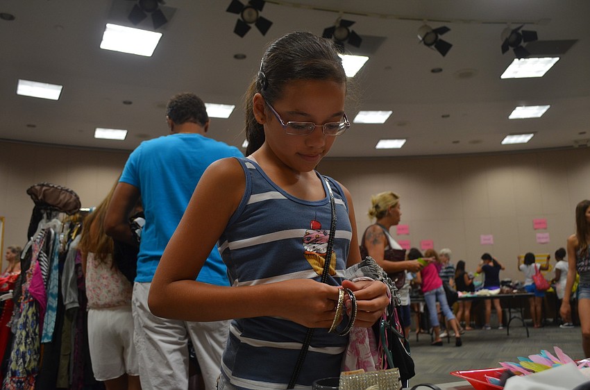 Alycia DeOliveira tries on some bangles.