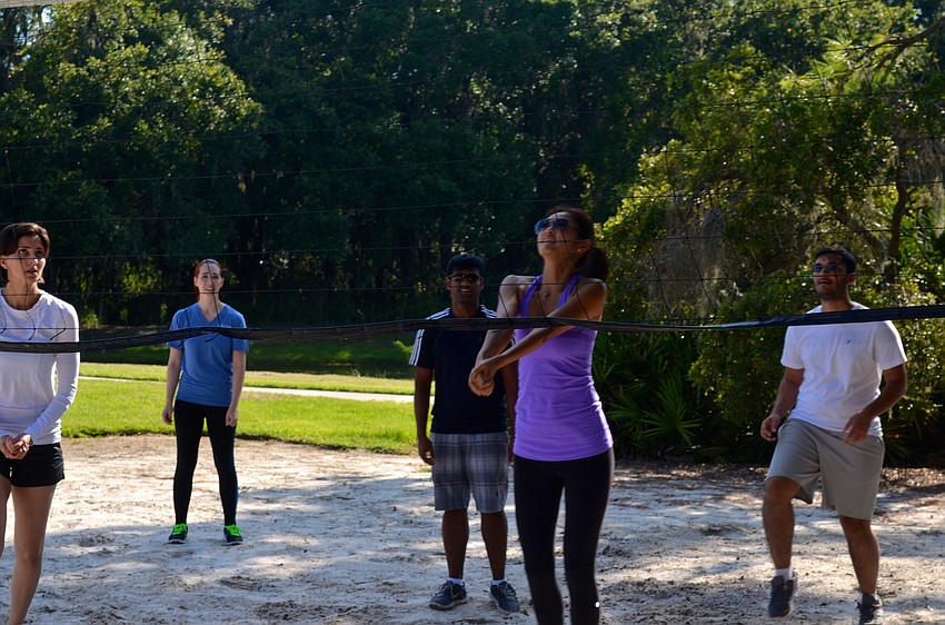 Teams of six compete in volleyball and other sports activities.