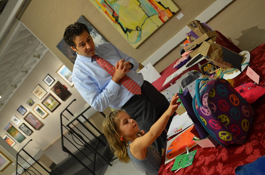 Lanie Fineman shows her dad, Steven Fineman, her work