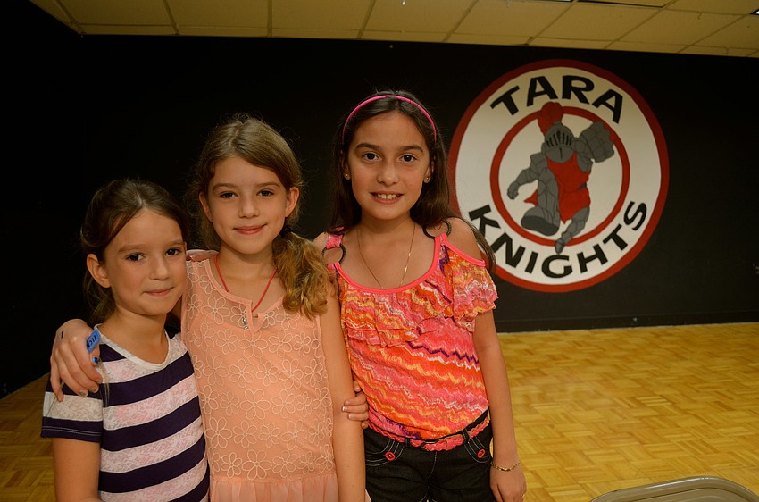 Elia and Kelsey Wilson pose with Jalenairam Murga.