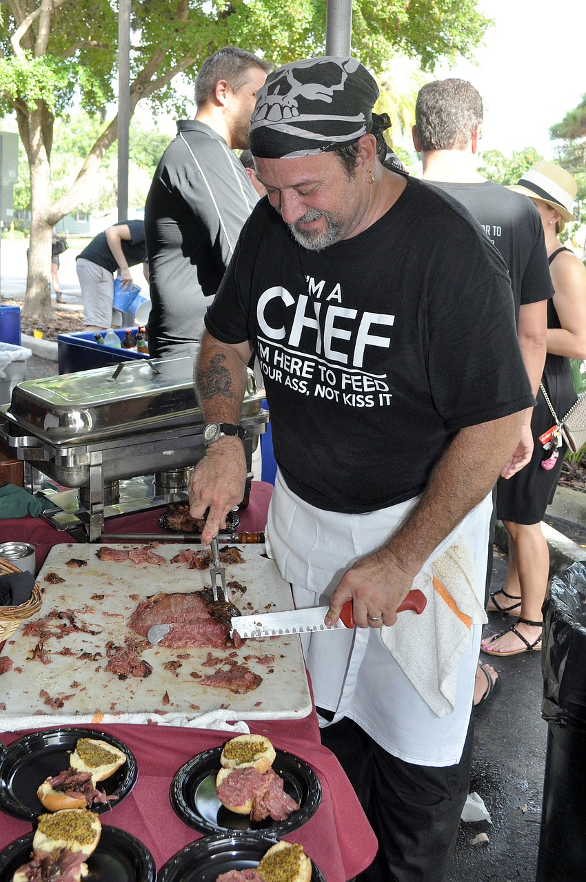 Chef John Teitsch prepares some house smoked pastrami silders at Mortonâ€™s Market Celebration of Brewing.