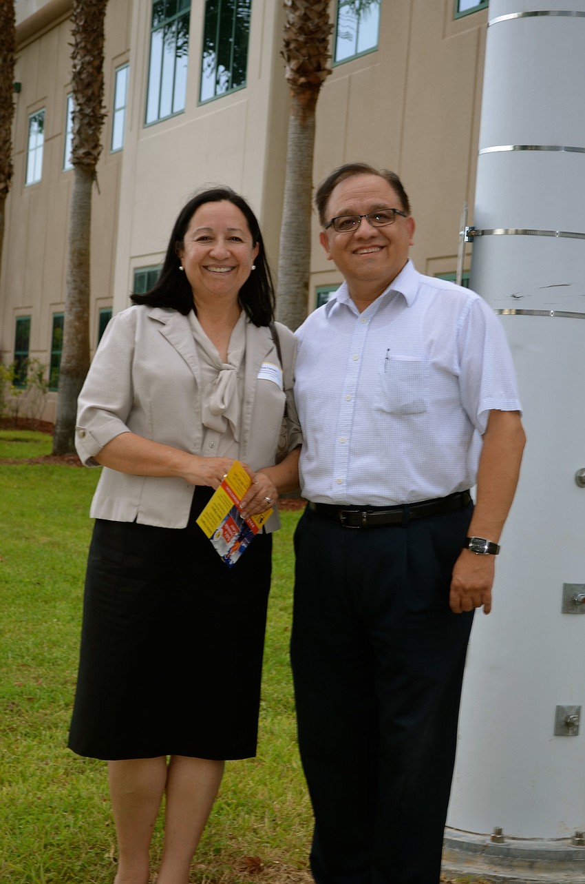 Luz and Luis Corcuera tour the school's campus to see the new solar energy devices.