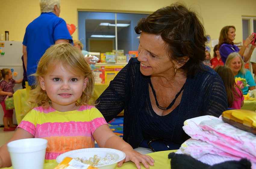 Lilly Stanton eats cereal beside her grandmother, Joan Stanton.