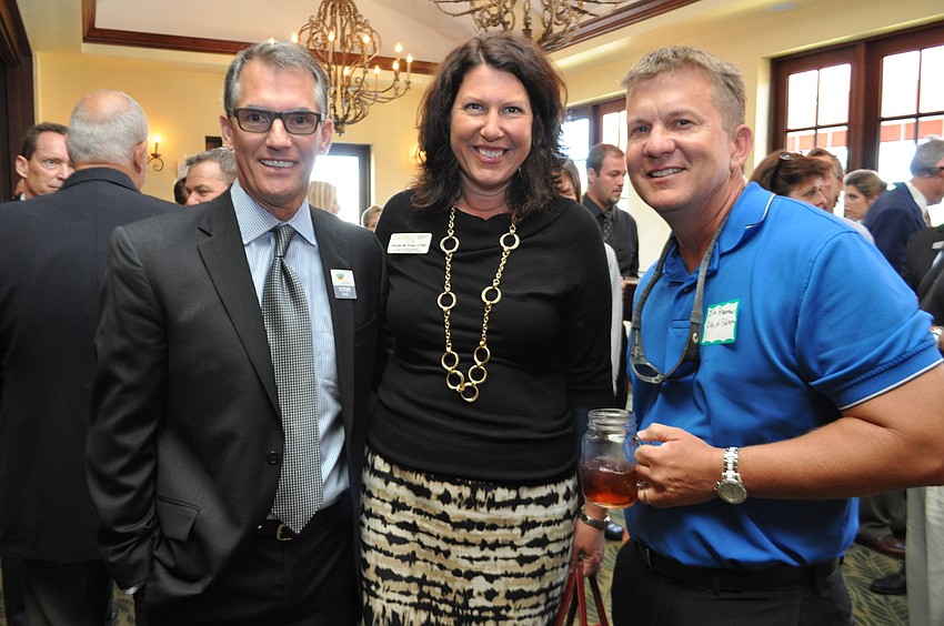 Steve Hall, of Alltrust, chats with Denise Pope, of Tidewell Hospice, and Jim Freeman, of the city of Palmetto