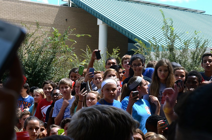 Sixth- through eighth-graders struggle for the best view of ALS Ice Bucket Challenge participants.