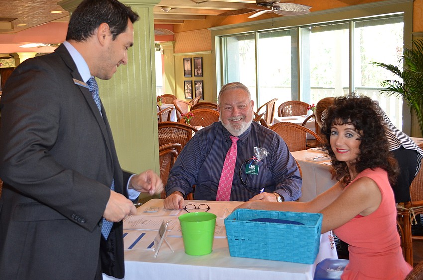 Silva, Dean and Jacobson-Jose Silva, Chase Bank, checks in for the Networking Luncheon with Jack Dean and Victoria Jacobson.